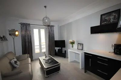 a living room with a couch and a table at From Hollywood to Bollywood 2 Bedrooms 2 Bathrooms - 1 min from Croisette&Beach, 12 Min from the Palais in Cannes