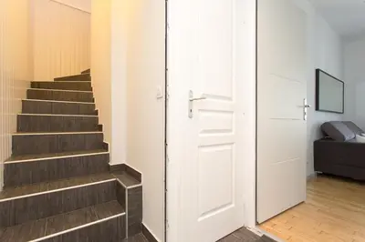 a stairway with a door leading up to a room with a stair at Teisseire Accomodations in Cannes