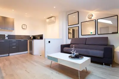 a living room with a couch and a table at Teisseire Accomodations in Cannes