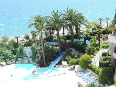 a water slide at a resort with palm trees at #Cannes Boccacabana Beach, Seafront, in Résid Pierre&Vacances Classé 3 Stars in Cannes