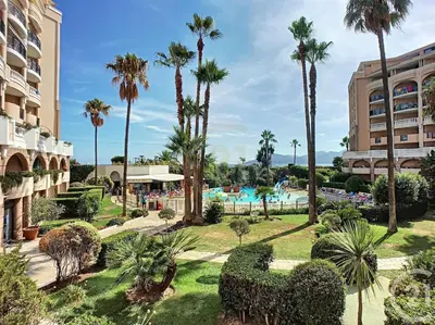a view of a resort with palm trees and a pool at #Cannes Boccacabana Beach, Seafront, in Résid Pierre&Vacances Classé 3 Stars in Cannes