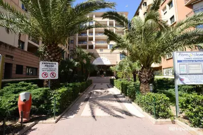 a sidewalk with palm trees and a building at #Cannes Boccacabana Beach, Seafront, in Résid Pierre&Vacances Classé 3 Stars in Cannes