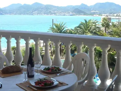 a table with two plates of food and wine on a balcony at #Cannes Boccacabana Beach, Seafront, in Résid Pierre&Vacances Classé 3 Stars in Cannes