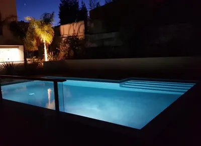 a swimming pool in front of a building at night at Secret Garden in Cannes