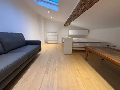 a staircase with a couch in a room with a window at Cannes, Le Suquet in Cannes