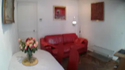 a living room with a red couch and a table at Cannes, Le Suquet in Cannes