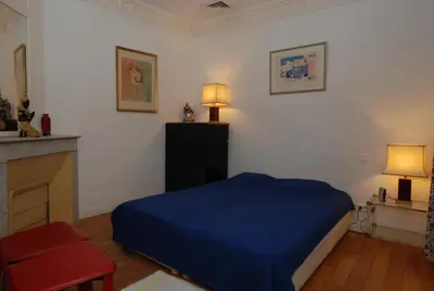 a bedroom with a blue bed in a room at Cannes, Le Suquet in Cannes