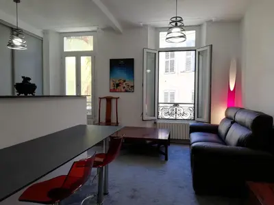 a living room with a table and a couch at Cannes, Le Suquet in Cannes