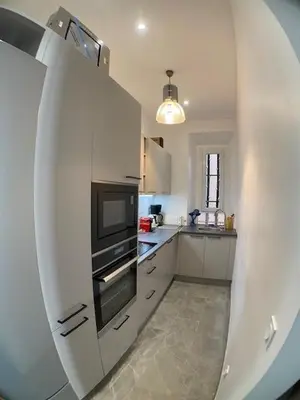a view of a kitchen with a large white refrigerator at Cannes, Le Suquet in Cannes