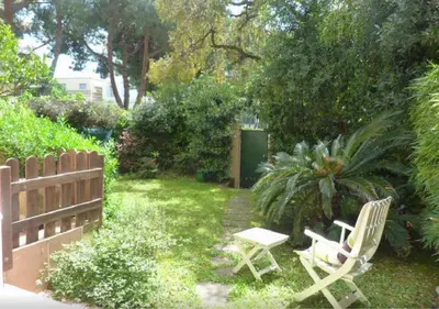 a yard with two chairs and a fence at Cannes Film Festival Beach Apartment in Cannes