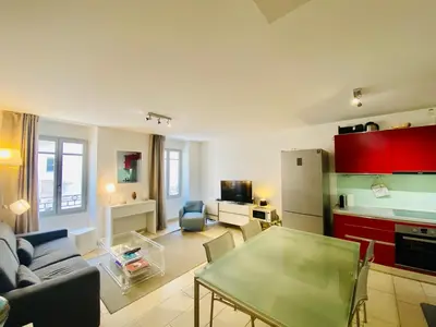 a living room with a couch and a table at Très Joli T3 Vieux Port Cannes in Cannes