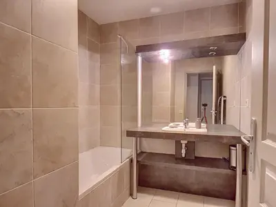 a bathroom with a sink and a shower and a tub at Très Joli T3 Vieux Port Cannes in Cannes