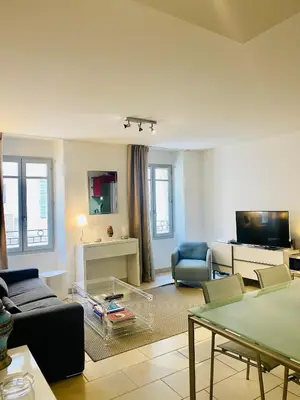 a living room with a couch and a table at Très Joli T3 Vieux Port Cannes in Cannes