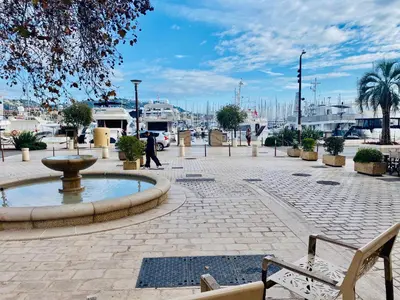 a person walking down a street with a fountain at Très Joli T3 Vieux Port Cannes in Cannes