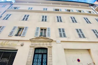 a large white building with windows and doors at Très Joli T3 Vieux Port Cannes in Cannes