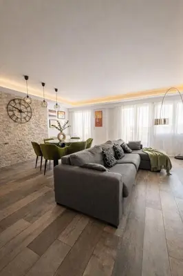 a white bedroom with a tv on the wall at Palladium Palais des Festivals in Cannes