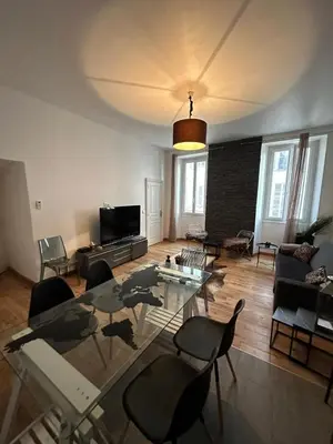 a living room with a glass table and chairs at CANNES FESTIVALS b in Cannes