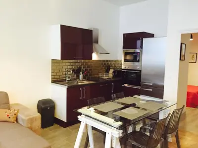 a kitchen with a table and a counter top at CANNES FESTIVALS b in Cannes