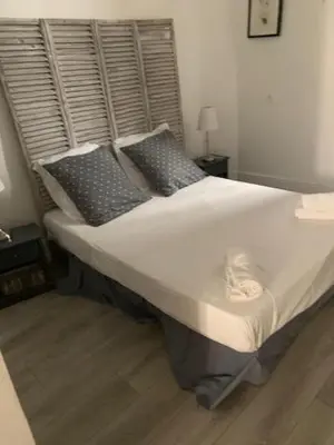 a bed with pillows and a cat sleeping on it at CANNES FESTIVALS b in Cannes