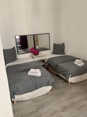 a room with two beds and a mirror at CANNES FESTIVALS b in Cannes