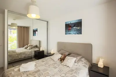 a bedroom with a bed with a teddy bear on a pillow at Le Petit Magellan in Cannes
