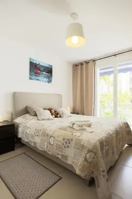 a dog laying on a bed in a bedroom at Le Petit Magellan in Cannes