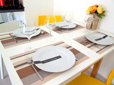a table with plates and wine glasses on it at Le Petit Magellan in Cannes