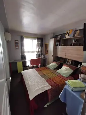 a bedroom with a bed and a table and a window at Agréable chambre d'hôte à 50M de la mer in Cannes