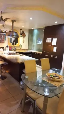 a kitchen with a counter and a table and chairs at Agréable chambre d'hôte à 50M de la mer in Cannes