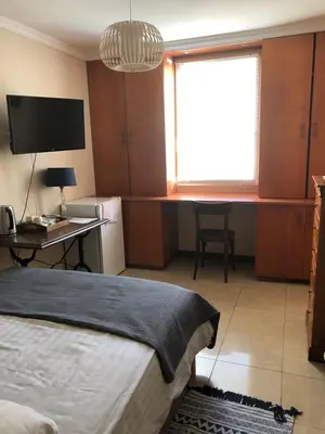 a bedroom with a bed and a desk with a computer at Agréable chambre d'hôte à 50M de la mer in Cannes