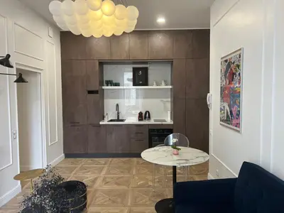 a living room with a blue couch and a table at Touchlux apartments in Cannes