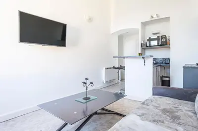 a living room with a couch and a table at IMMOGROOM - Center - Modern - 10 min from Palais des Festivals in Cannes