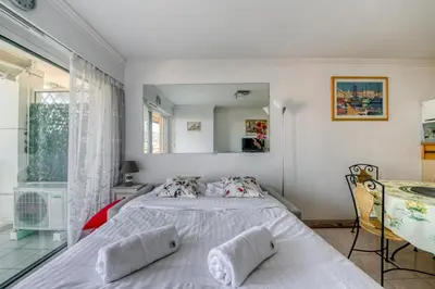 a bedroom with a bed and a mirror at IMMOGROOM - Sea view - Swimming Pool - Terrace- Clim in Cannes