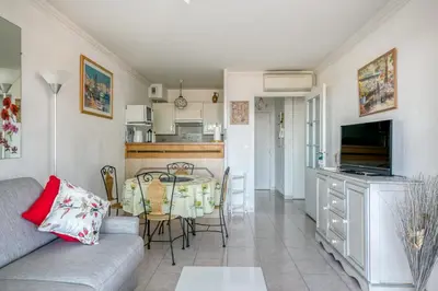 a living room with a couch and a table at IMMOGROOM - Sea view - Swimming Pool - Terrace- Clim in Cannes