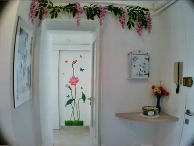 a hallway with a door with flowers on the wall at Boite d'Amour in Cannes