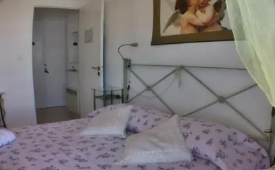 a bedroom with a bed with a picture on the wall at Boite d'Amour in Cannes
