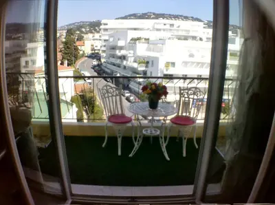 a balcony with a table and chairs on a balcony at Boite d'Amour in Cannes