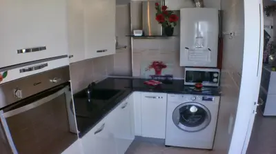 a kitchen with a washing machine and a washer at Boite d'Amour in Cannes