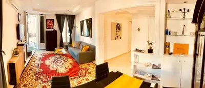 a living room with a couch and a table at Apartment 3 Pieces in Cannes