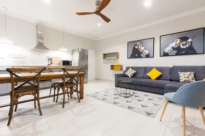a living room with a blue couch and a table at Appartement vue Mer, Suquet et Palais avec parking in Cannes