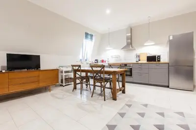 a kitchen with a table and chairs and a television at Appartement vue Mer, Suquet et Palais avec parking in Cannes
