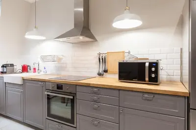 a kitchen with a black microwave on a counter at Appartement vue Mer, Suquet et Palais avec parking in Cannes