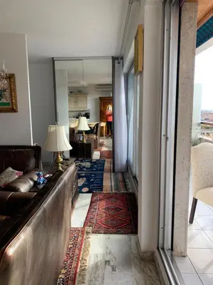 a living room with a couch and a table at Résidence Le Président - Forville in Cannes