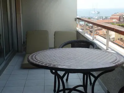 a table and chairs on a balcony with a view at Résidence Le Président - Forville in Cannes