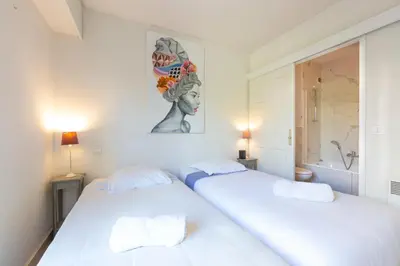 a living room with a couch and a table at Apartment 2 bedrooms2 bathroomsdouble terrace & Garden in Palm beach area in Cannes