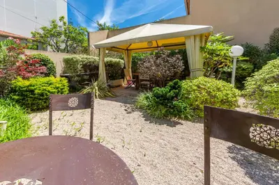 two beds in a room with a window at Apartment 2 bedrooms2 bathroomsdouble terrace & Garden in Palm beach area in Cannes