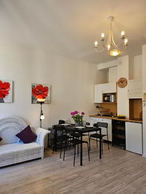 a living room with a table and a kitchen at SUQUET - BEACH 100m & PALAIS DES FESTIVALS 600m in Cannes