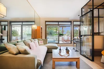 a living room with a couch and a table at Gray d'Albion YourHostHelper in Cannes