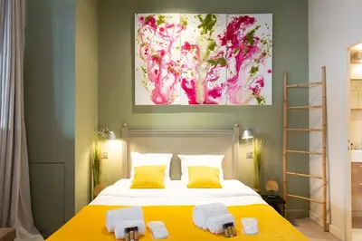 a bedroom with two beds and a painting on the wall at Gray d'Albion YourHostHelper in Cannes