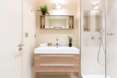 a bathroom with a white sink and a shower at Gray d'Albion YourHostHelper in Cannes